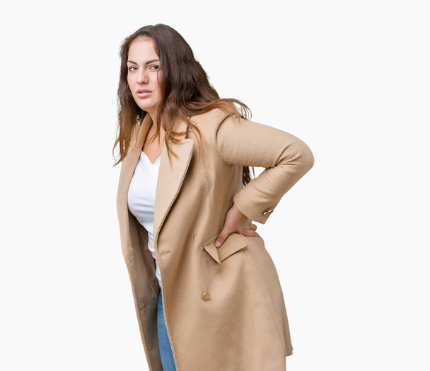 Beautiful plus size young woman wearing winter coat over isolated background Suffering of backache, touching back with hand, muscular pain - Φωτογραφία, εικόνα