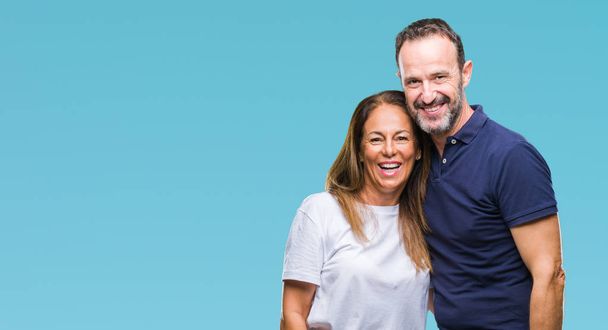 Middle age hispanic casual couple over isolated background with a happy and cool smile on face. Lucky person. - Fotografie, Obrázek