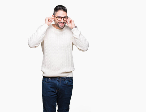 Young handsome man wearing glasses over isolated background covering ears with fingers with annoyed expression for the noise of loud music. Deaf concept. - Photo, Image