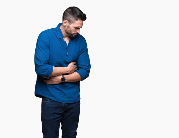 Young handsome man over isolated background with hand on stomach because nausea, painful disease feeling unwell. Ache concept. - Foto, afbeelding
