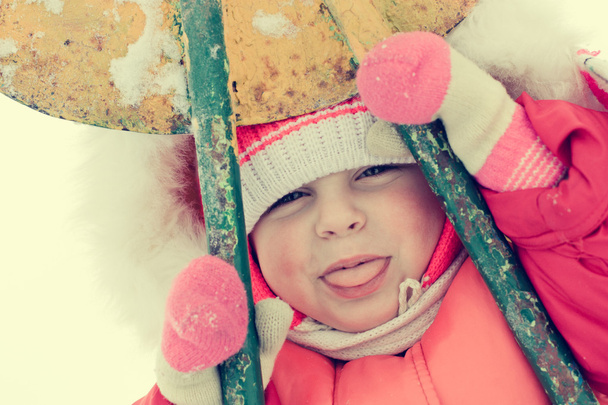 Beautiful happy kid in the red warm clothing - Foto, imagen