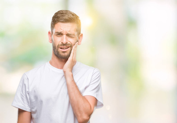 Young handsome man over isolated background touching mouth with hand with painful expression because of toothache or dental illness on teeth. Dentist concept. - Φωτογραφία, εικόνα