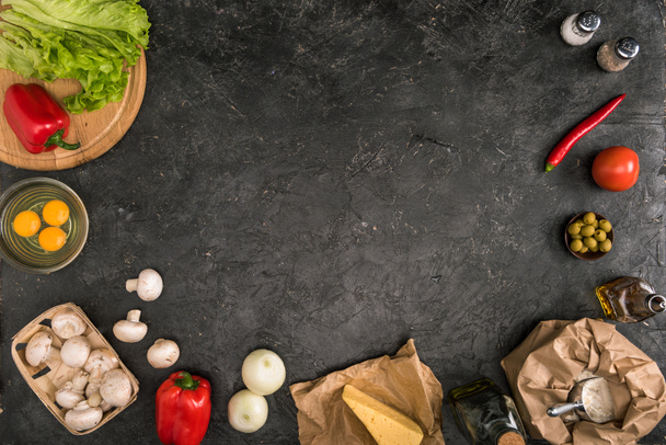 top view of pizza ingredients with copy space on grey background - 写真・画像