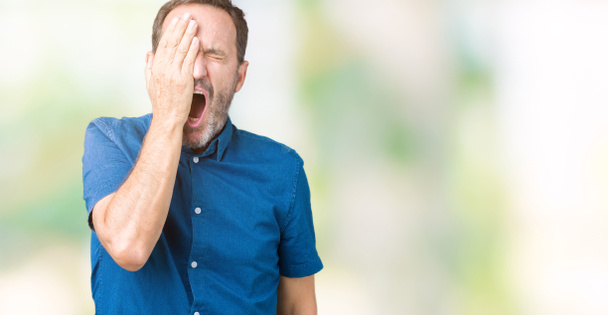 Handsome middle age elegant senior man over isolated background Yawning tired covering half face, eye and mouth with hand. Face hurts in pain. - Photo, Image