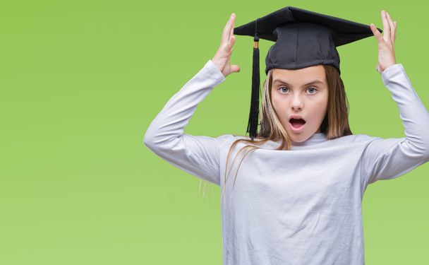 Young beautiful girl wearing graduate cap over isolated background suffering from headache desperate and stressed because pain and migraine. Hands on head. - Photo, image