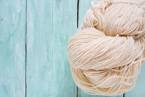 knitting yarn hanks on wooden surface - 写真・画像