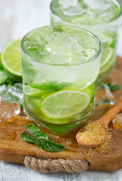 Mojito and ingredients on white wooden surface - 写真・画像
