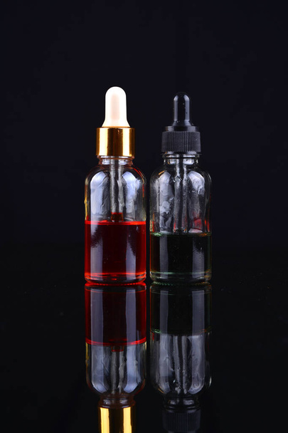 Electronic cigarette liquid flavour isolate on black - 写真・画像