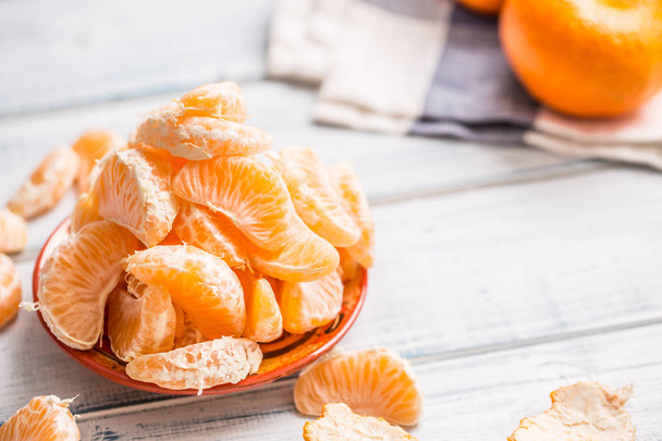 Fresh pieces of tangerines mandarin on the plate or in a bowl. - Φωτογραφία, εικόνα