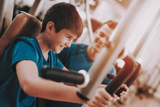 Young Father and Son Doing Exercises in Sport Club - Foto, Imagen