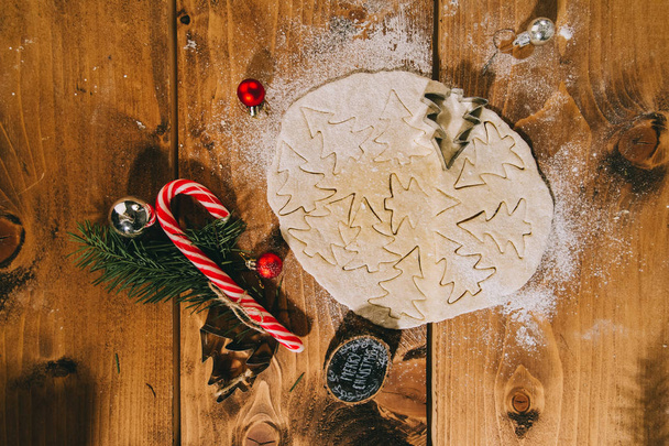 Preparing Christmas cookies on a wooden background, flatlay,top view, retro filter applied, home christmas concept. - Foto, afbeelding