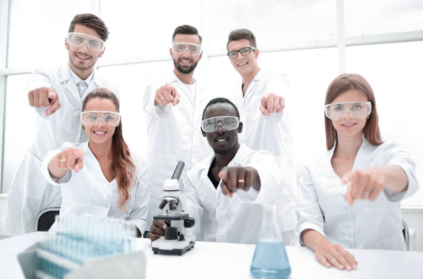 Group of young successful scientists posing for camera - Photo, Image
