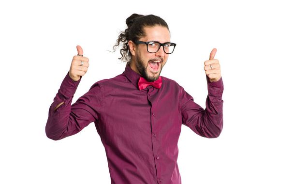 Happy man in glasses shows thumbs up isolated on white background. - Foto, imagen