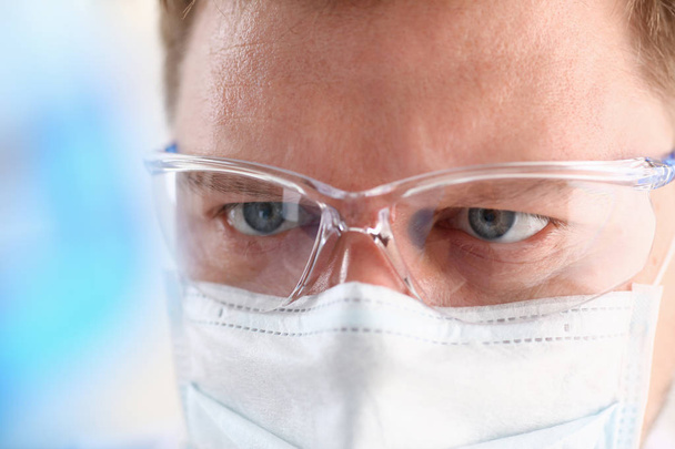 A portrait of a young surgeon chemist doctor looks - 写真・画像