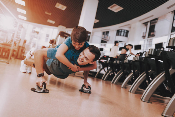 Young Father and Son Doing Exercises in Sport Club - Fotografie, Obrázek