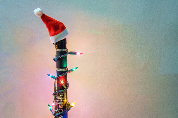 Saisonnier vacances instrument de musique clarinette avec Noël santa chapeau et lumières
 - Photo, image