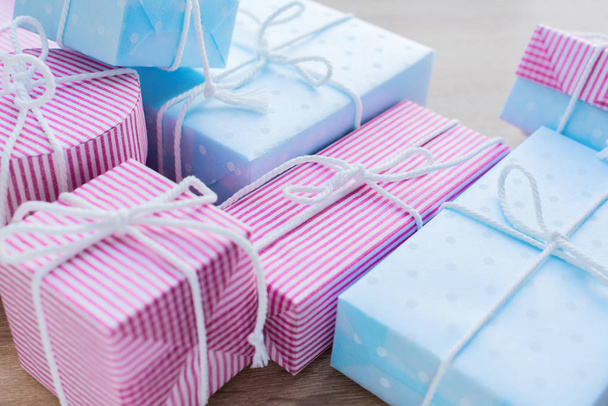 Birthday and Christmas gifts. Festive pastel pink blue box with cord on blue background. Copy space - Photo, Image