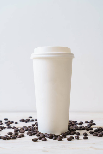 Paper cup of takeaway coffee on wood background - Photo, Image