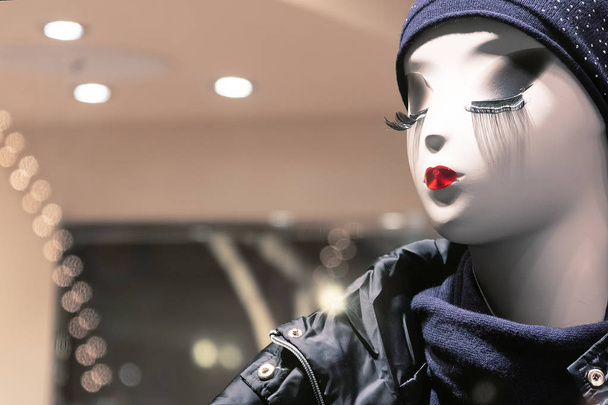 Mannequin in the store with red lips, white skin and long eyelashes - Photo, Image