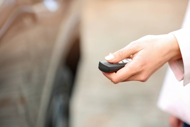 Closeup view of woman opening car door with remote key. Space for text - Foto, Imagem