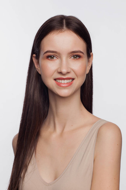 Portrait of a smiling beautiful young woman. White background - Fotó, kép