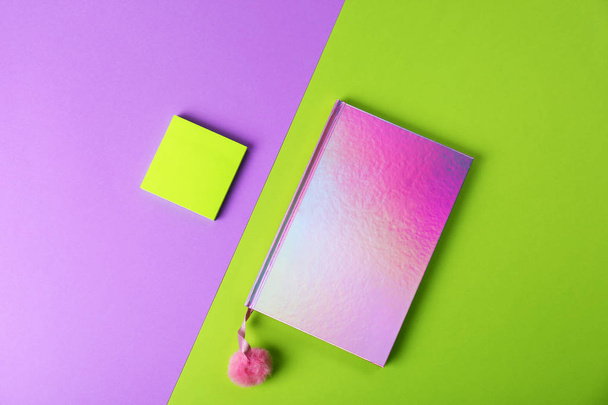 Pink female notebook with pompom and note papers on color background, flat lay - Fotoğraf, Görsel