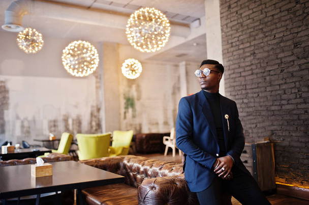 Homem americano africano na moda em terno e óculos posados no café
. - Foto, Imagem