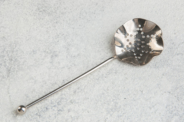 Vintage metal spoon strainer on concrete background. Copy space for text. - Fotografie, Obrázek