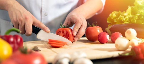 Chef prepares fresh vegetables. Cooking, healthy nutrition concept - Foto, afbeelding