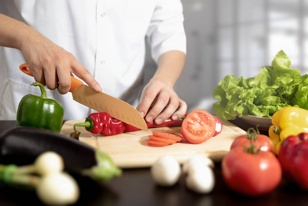 Chef prepares fresh vegetables. Cooking, healthy nutrition concept - Fotó, kép