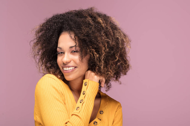 Young afro american woman posing over pink background smiling . Human emotions. - Foto, Imagen