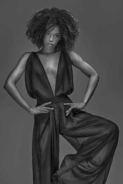 Elegant beautiful african american woman posing in sexy black dress. Studio shot. - Foto, imagen