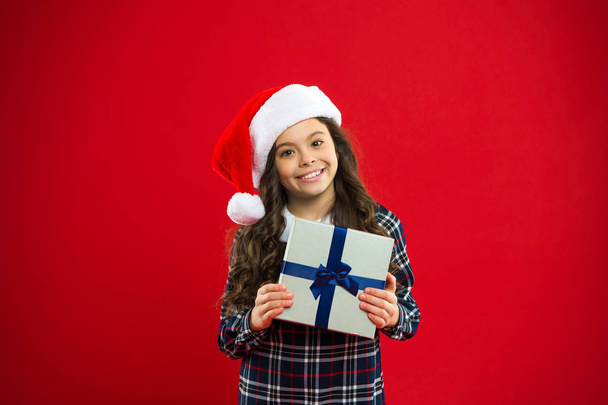 Happy winter holidays. Small girl. Present for Xmas. Childhood. Little girl child in santa red hat. Christmas shopping. New year party. Santa claus kid. i made it for you - Foto, Imagem