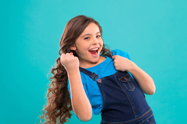 Happy winner. Successful happy kid. Achieve success. Kid cheerful celebrate victory. Girl cute child long curly hair happy smiling. Celebrate victory or achievement. Child psychology and development - Foto, imagen