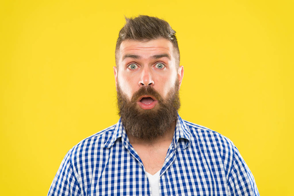 Guy surprised face expression. Hipster with beard and mustache emotional surprised expression. Rustic surprised macho. Surprising news. Man bearded hipster wondering face yellow background close up - Фото, зображення