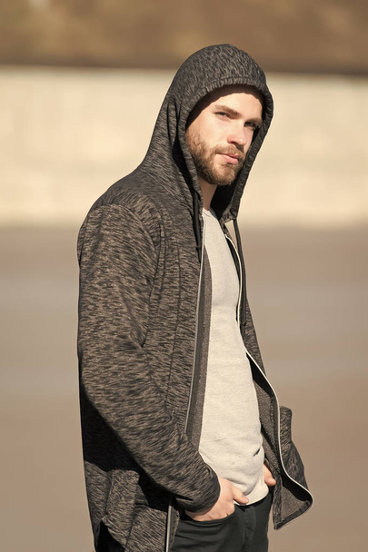 Macho with beard in hoodie on sunny outdoor, fashion. Man wear sweatshirt, casual style. Mens fashion, style, sportswear. Lifestyle for active and healthy man, sport - Fotoğraf, Görsel