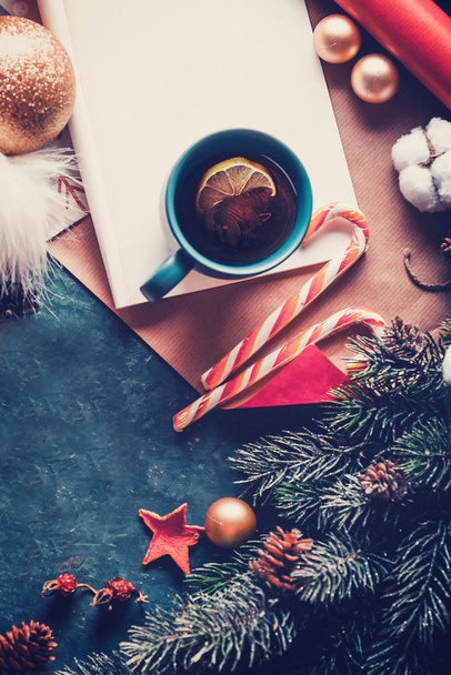 Christmas fir tree, decorations and hot tea with lemon. A letter to Santa Claus. View from above - Photo, Image