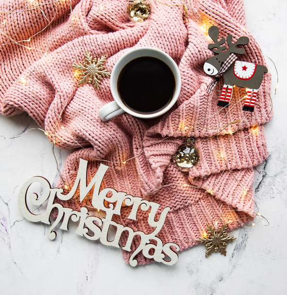 Cup of coffe, sweater and garland - flat lay - Photo, image