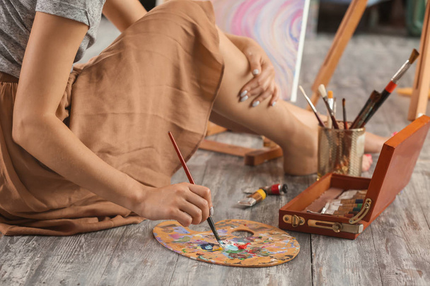 Жіночий художник малює картини в майстерні
 - Фото, зображення