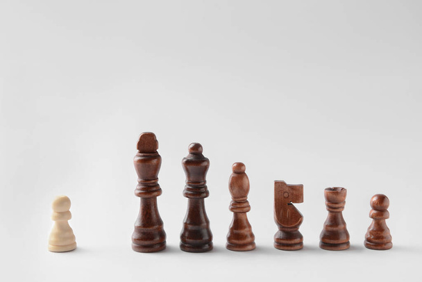 Chess pieces on light background - Фото, зображення