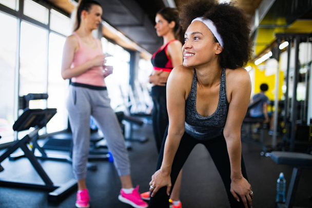 Beautiful happy women exercising together in gym - Fotoğraf, Görsel