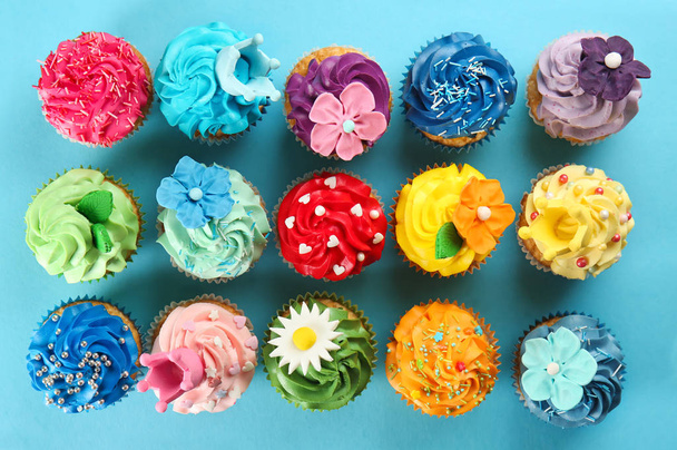 Delicious cupcakes on color background - Photo, Image