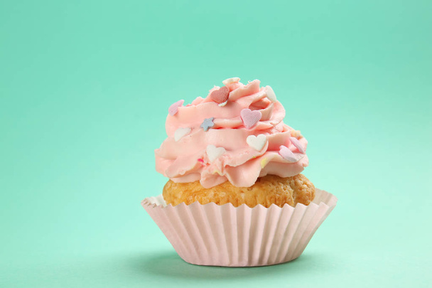 Tasty cupcake on color background - Valokuva, kuva