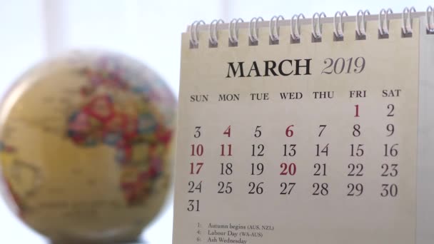 Motion of March 2019 calendar with blur earth globe turning background - Footage, Video