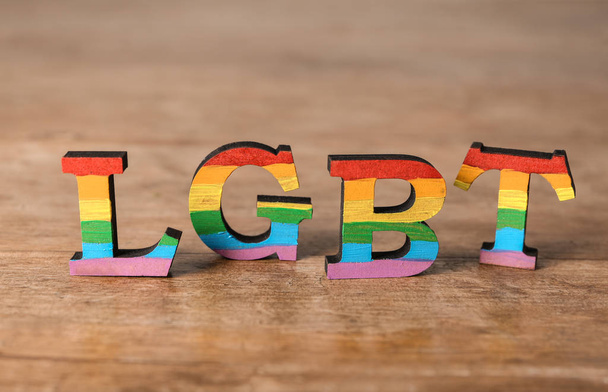 Rainbow letters LGBT on wooden table - Foto, Imagen
