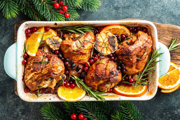 Christmas turkey legs baked with cranberries, orange and rosemary. Delicious festive dish for Christmas time. Top view,  flat lay - Photo, Image