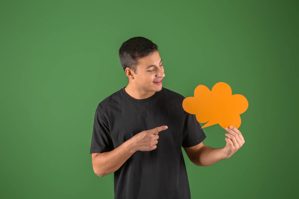Young man with speech bubble on color background - Photo, Image