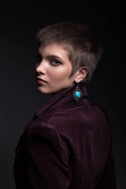 Beautiful portrait of a teenager girl. With a beautiful make-up in a burgundy jacket. - Photo, Image