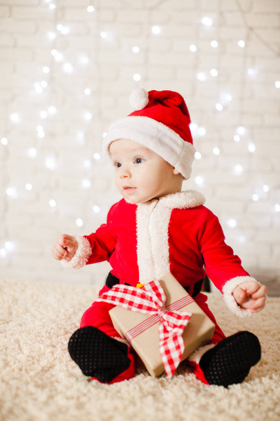 Little Santa baby over defocused lights wall - Фото, изображение