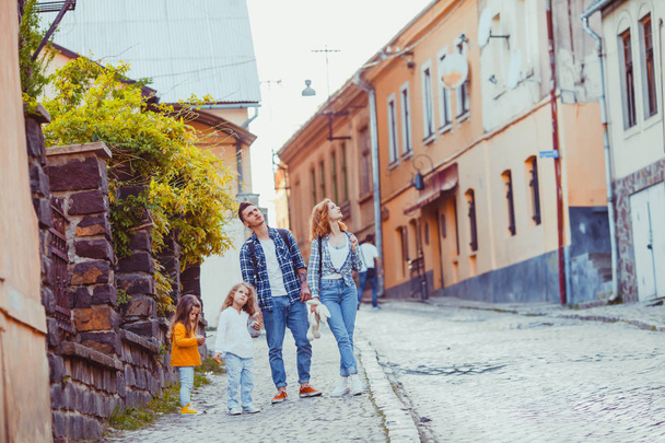 Summer portrait of family strolling around the city - Foto, Imagen